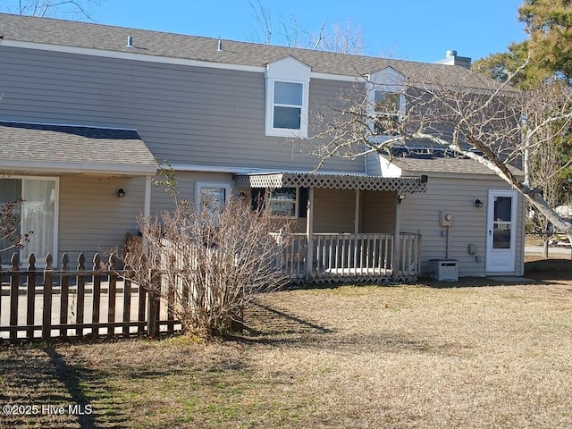 rear view of property with a yard and covered porch