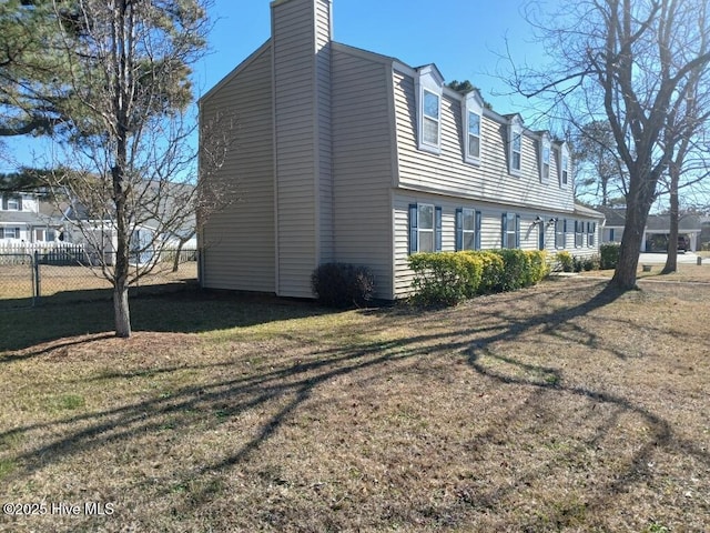 view of home's exterior with a lawn