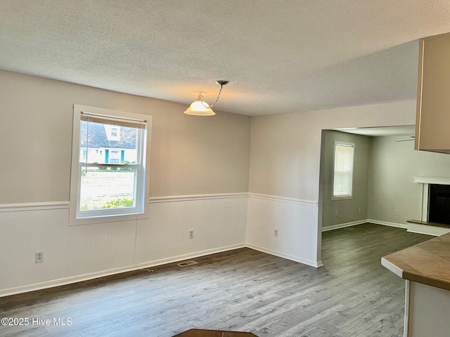 interior space with wood-type flooring and a textured ceiling