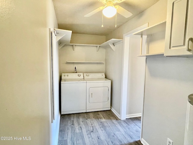 washroom with washer and clothes dryer, light hardwood / wood-style floors, and ceiling fan