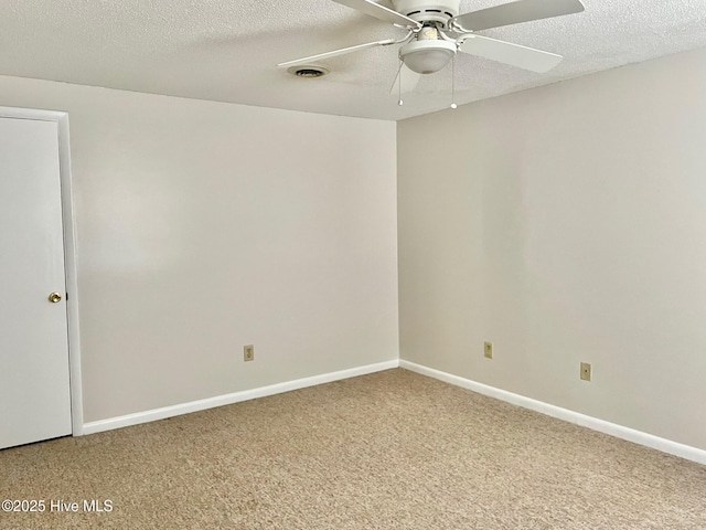 unfurnished room with ceiling fan, carpet, and a textured ceiling