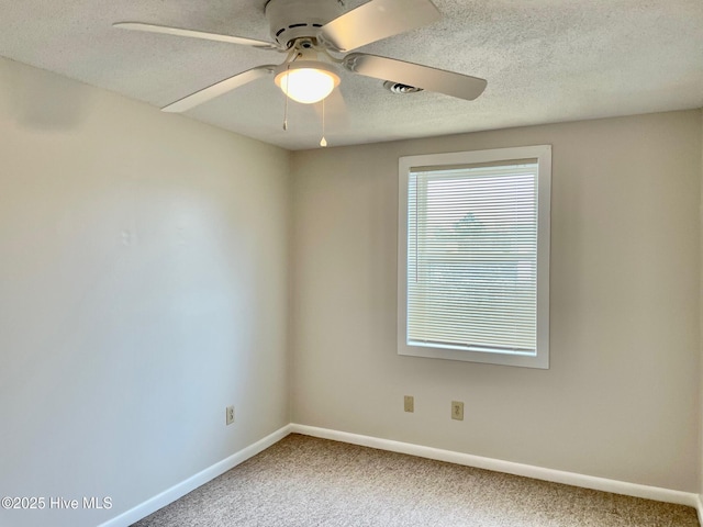 empty room featuring ceiling fan, carpet floors, and a textured ceiling