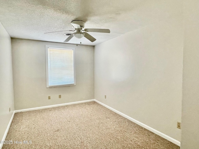 unfurnished room with ceiling fan, carpet, and a textured ceiling