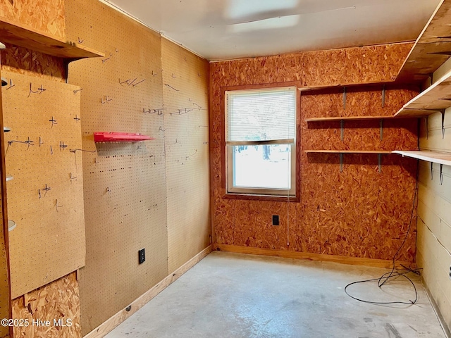 spare room featuring a workshop area and concrete floors