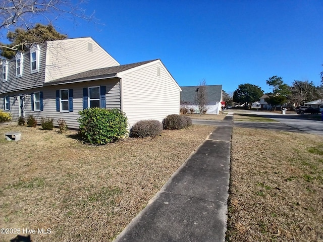 view of property exterior featuring a lawn