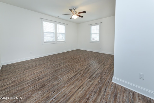 unfurnished room with dark wood-type flooring, ceiling fan, and a healthy amount of sunlight