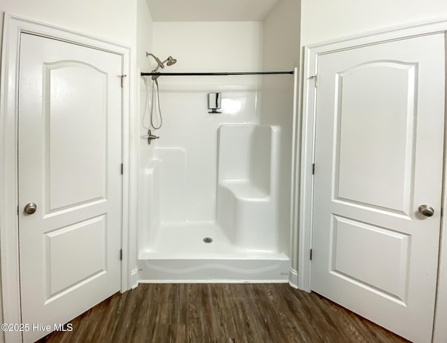 bathroom featuring wood-type flooring and a shower