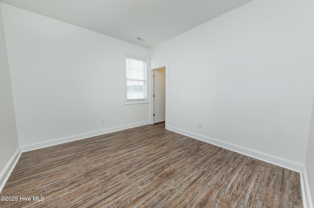 unfurnished room featuring dark wood-type flooring