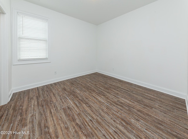 empty room with dark wood-type flooring