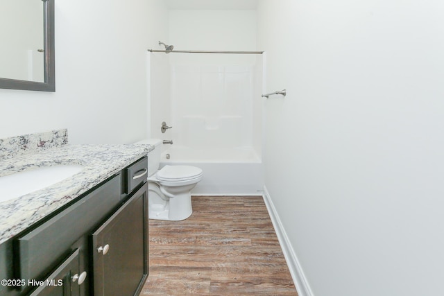 full bathroom featuring vanity, wood-type flooring,  shower combination, and toilet