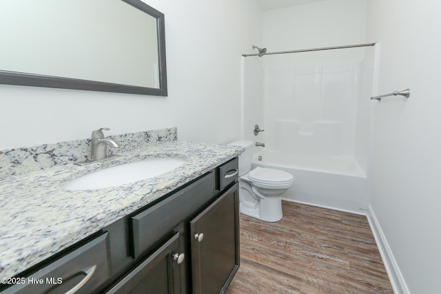 full bathroom with hardwood / wood-style flooring, vanity, toilet, and shower / bath combination