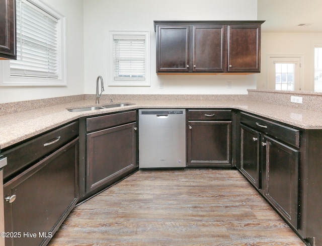 kitchen with sink, dark brown cabinets, light hardwood / wood-style floors, and dishwasher