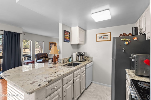 kitchen with a peninsula, a sink, white cabinets, electric stove, and dishwasher