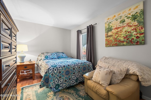 bedroom featuring wood finished floors