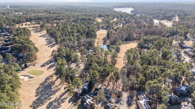 birds eye view of property featuring a forest view