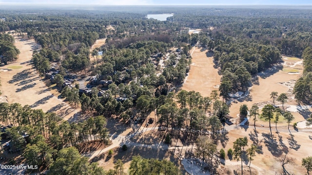 drone / aerial view featuring a forest view