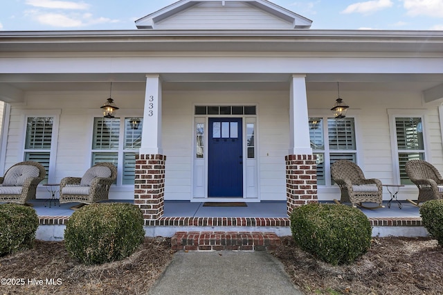 view of exterior entry featuring a porch