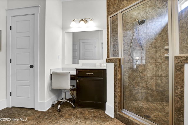 bathroom featuring vanity and a shower with shower door