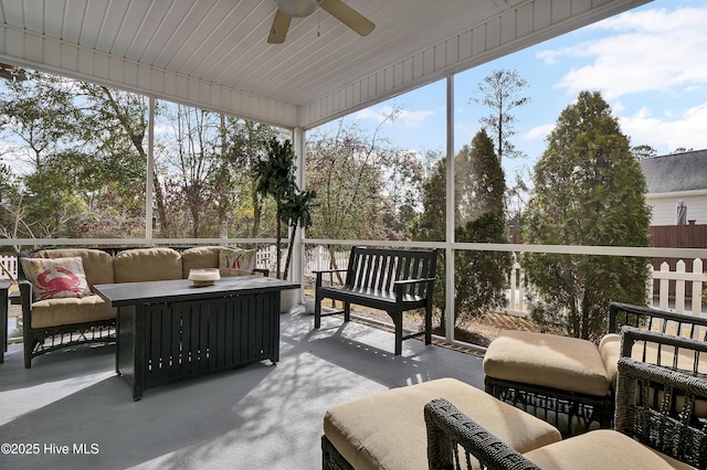 sunroom / solarium with a healthy amount of sunlight and ceiling fan