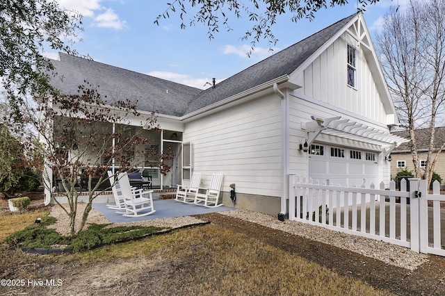 rear view of house featuring a pergola and a patio