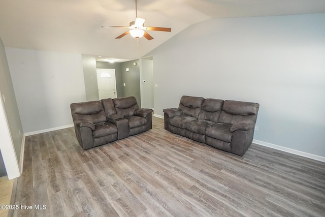 living room featuring lofted ceiling, wood-type flooring, and ceiling fan