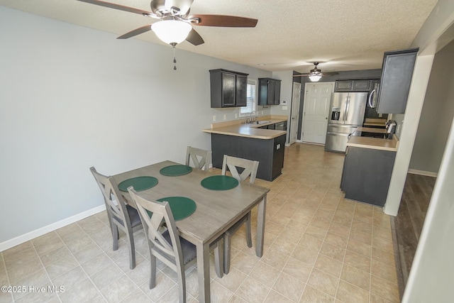 dining area featuring sink and a textured ceiling