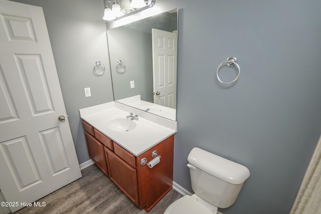 bathroom featuring vanity, toilet, and wood-type flooring