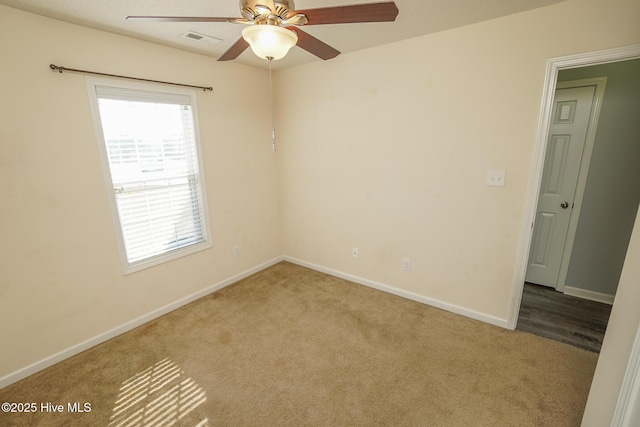 carpeted empty room featuring ceiling fan