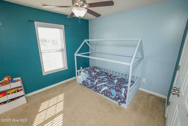 carpeted bedroom with ceiling fan