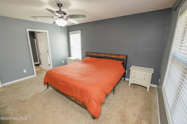 bedroom with ceiling fan and light carpet