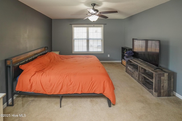 bedroom with ceiling fan and light colored carpet