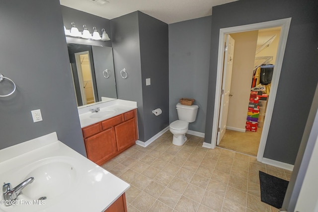 bathroom featuring tile patterned floors, vanity, and toilet