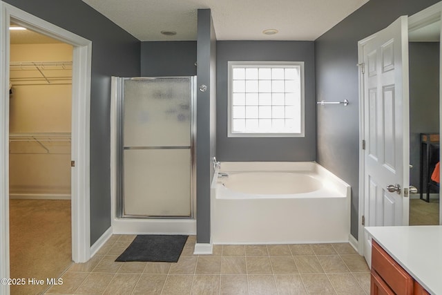 bathroom featuring plus walk in shower and vanity