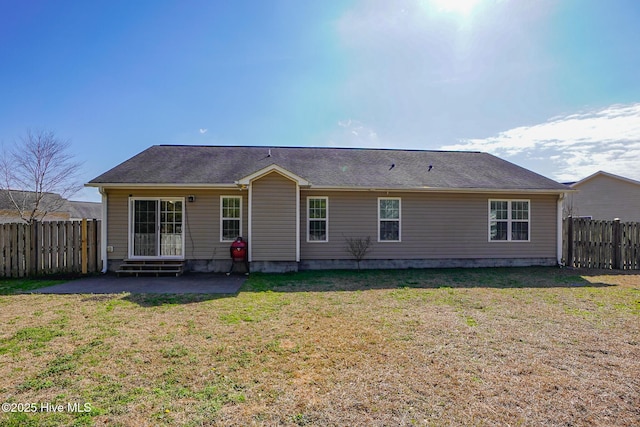 back of property featuring a yard and a patio area