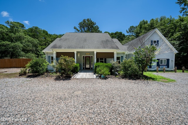 cape cod house featuring covered porch