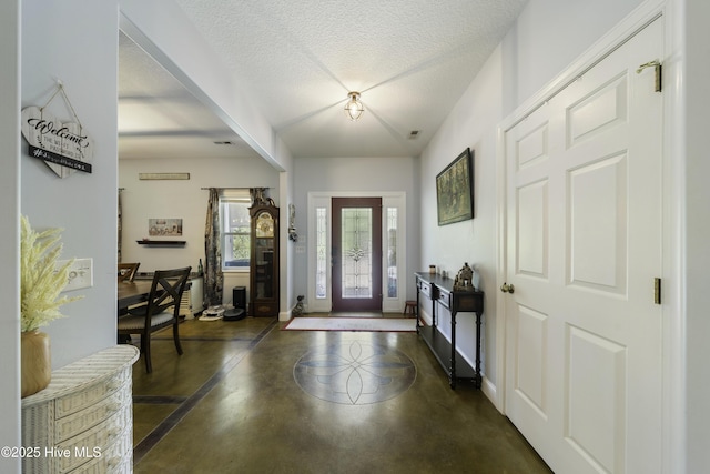 foyer entrance featuring a textured ceiling