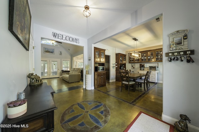 interior space with french doors and vaulted ceiling