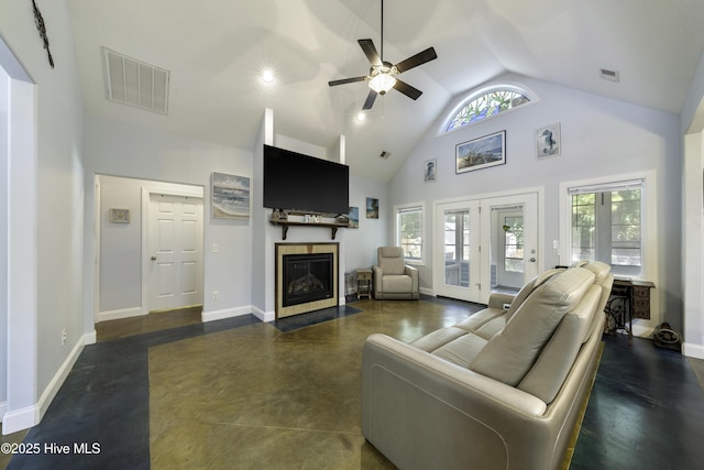 living room with a tiled fireplace, ceiling fan, high vaulted ceiling, and french doors