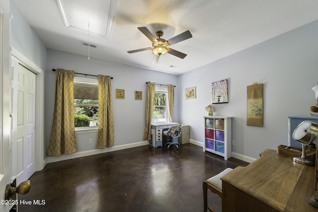 home office with ceiling fan and a textured ceiling