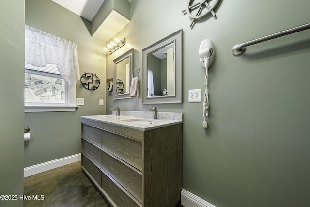 bathroom featuring vanity and concrete flooring