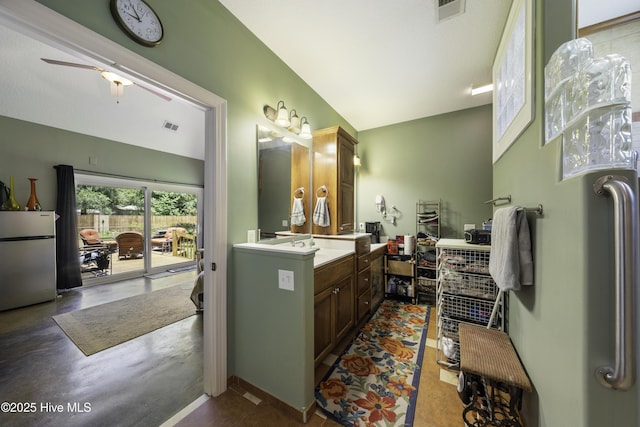 bathroom with lofted ceiling and vanity