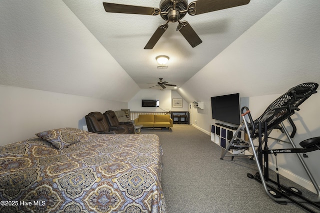 bedroom featuring vaulted ceiling, carpet floors, and a textured ceiling