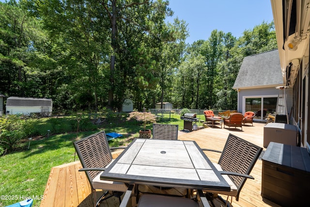 deck with a yard, an outdoor hangout area, and a shed