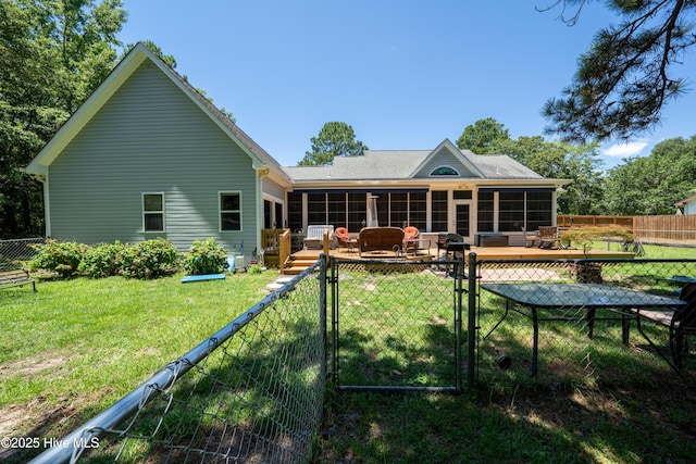 back of house featuring a sunroom, a yard, and a deck