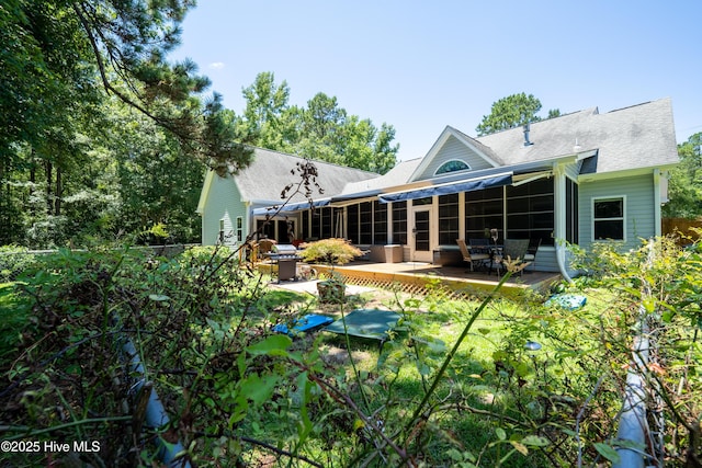 rear view of house featuring a deck and a patio