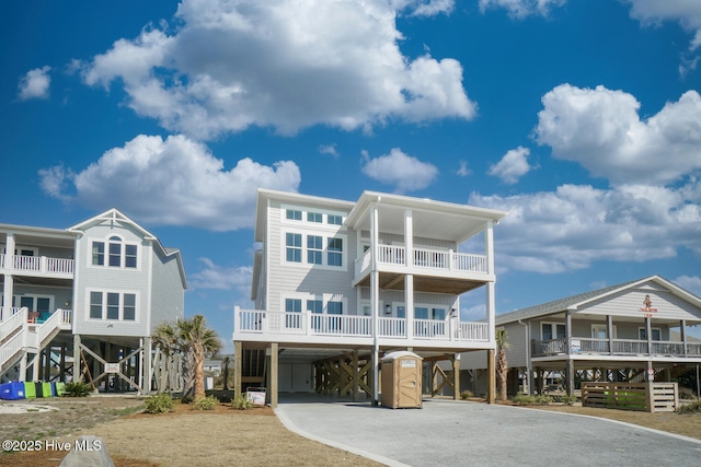 5228 E Beach Dr, Oak Island, NC 28465 - view of front facade with driveway and a carport