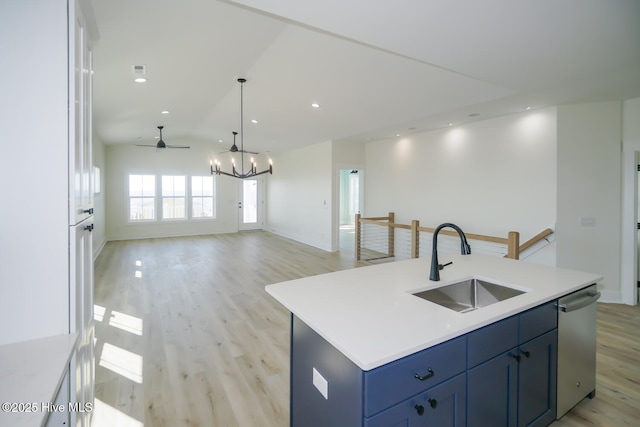 5228 E Beach Dr, Oak Island, NC 28465 - kitchen featuring open floor plan, stainless steel dishwasher, a sink, an island with sink, and light wood-style flooring