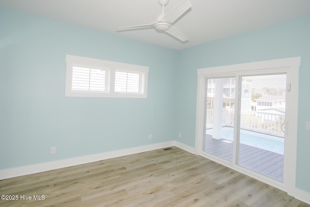 5228 E Beach Dr, Oak Island, NC 28465 - unfurnished room featuring baseboards, a wealth of natural light, wood finished floors, and ceiling fan