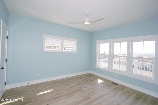 5228 E Beach Dr, Oak Island, NC 28465 - spare room with baseboards, visible vents, wood finished floors, and ceiling fan