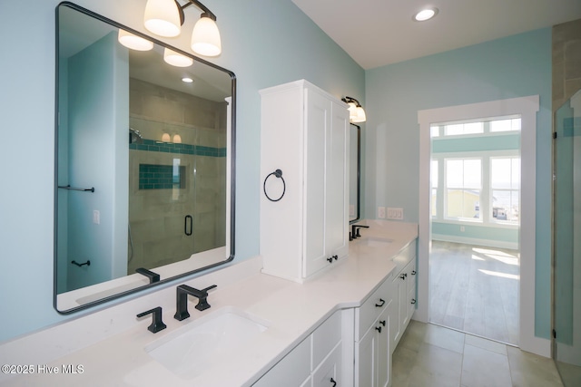 5228 E Beach Dr, Oak Island, NC 28465 - full bathroom with double vanity, a sink, a stall shower, and recessed lighting
